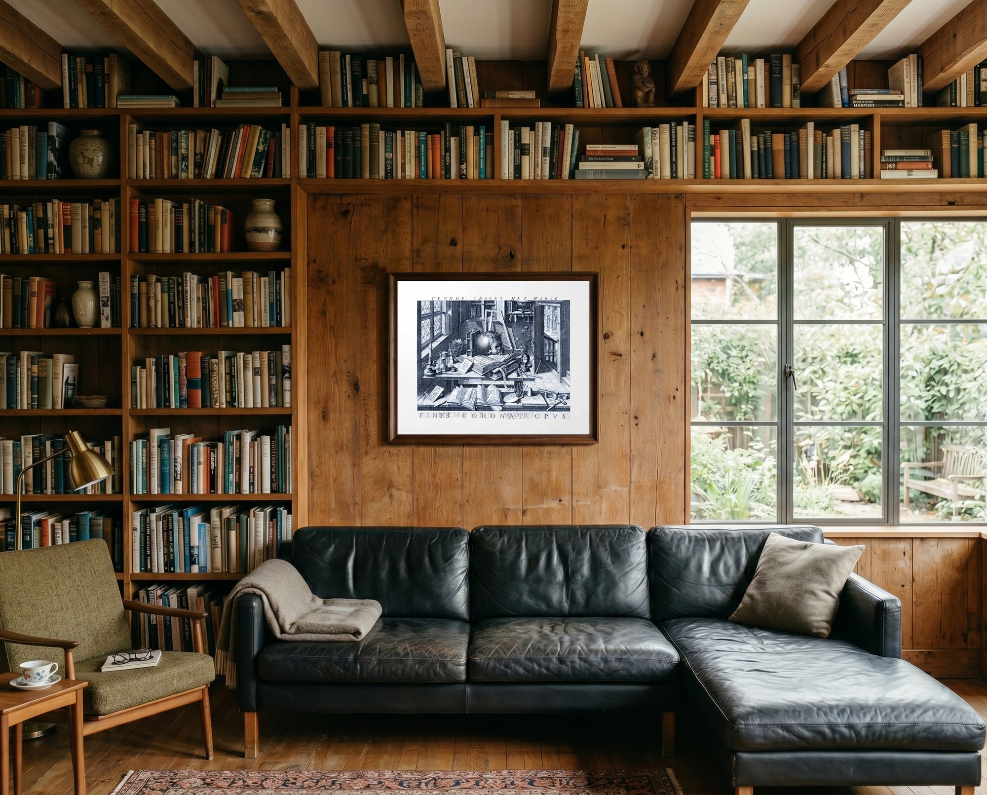 Living room with a black leather sofa, bookshelves, and a framed picture on a wooden wall.